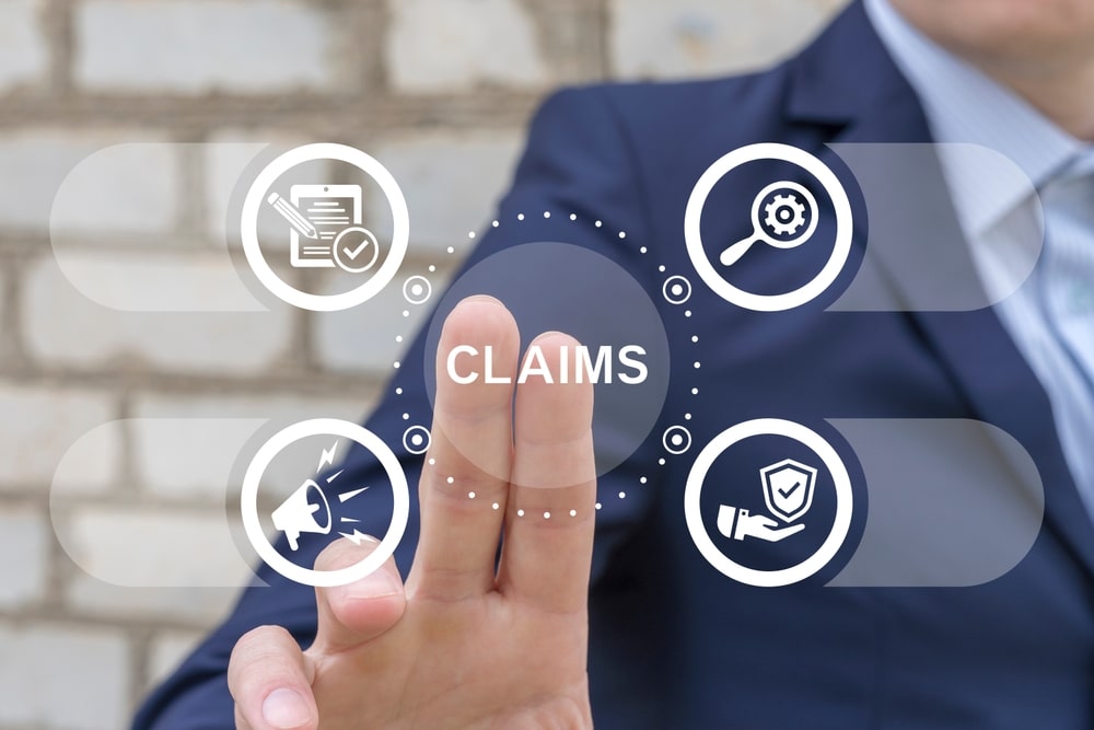 BusinessManWorkingOnVirtualTouchScreenPressesWordClaims