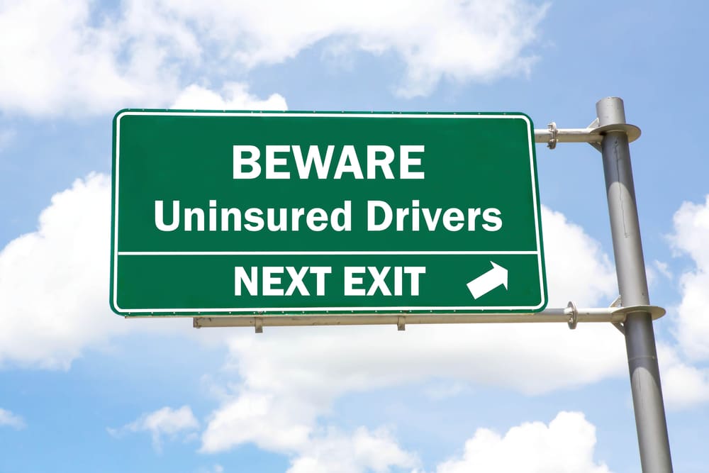 GreenOverheadRoadSignWithABewareOfUninsuredDrivers