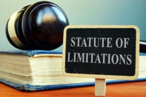 StatuteOfLimitationsSignBookAndGavel | Detroit Personal Injury Attorneys Gavel and book with sign reading "Statute of Limitations," symbolizing legal time limits in Michigan personal injury claims.