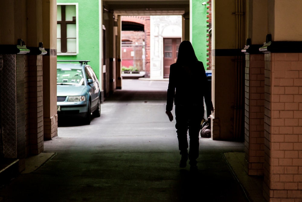 WomanWalkingInATunnelPassageToTheParkingArea