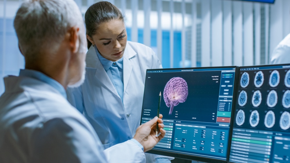 TwoMedicalScientistsInTheBrainResearchLaboratoryDiscussingProgress