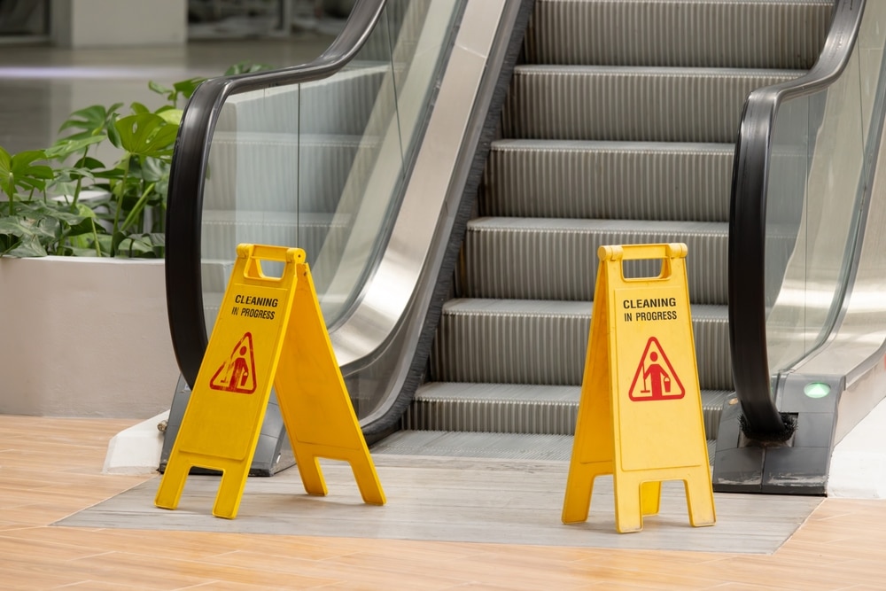TwoYellowCautionSignsArePlacedOnTheStepsOf