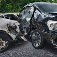 Damaged vehicles after a serious car accident, emphasizing the impact of collisions and the importance of Personal Injury Protection (PIP) benefits in Michigan.