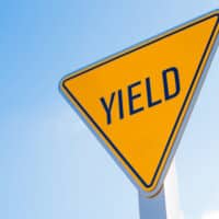 Yield traffic sign against a clear blue sky, emphasizing the importance of yielding in accident prevention, particularly relevant to failure to yield car accident claims in Detroit.