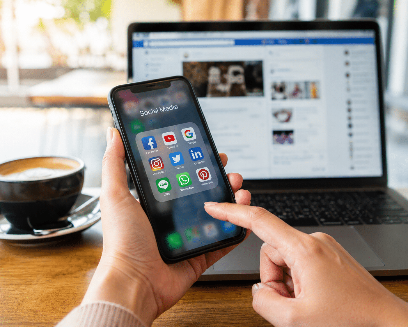 Social media apps on smartphone and laptop illustrating impact on car accident injury claim.